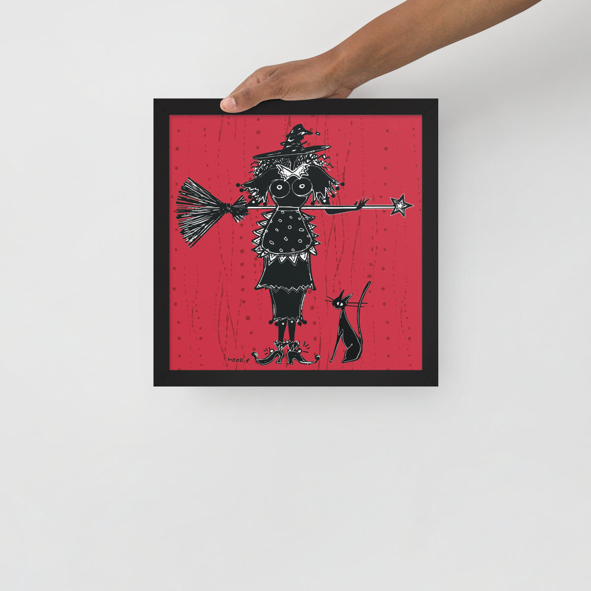 A witch holds a broom