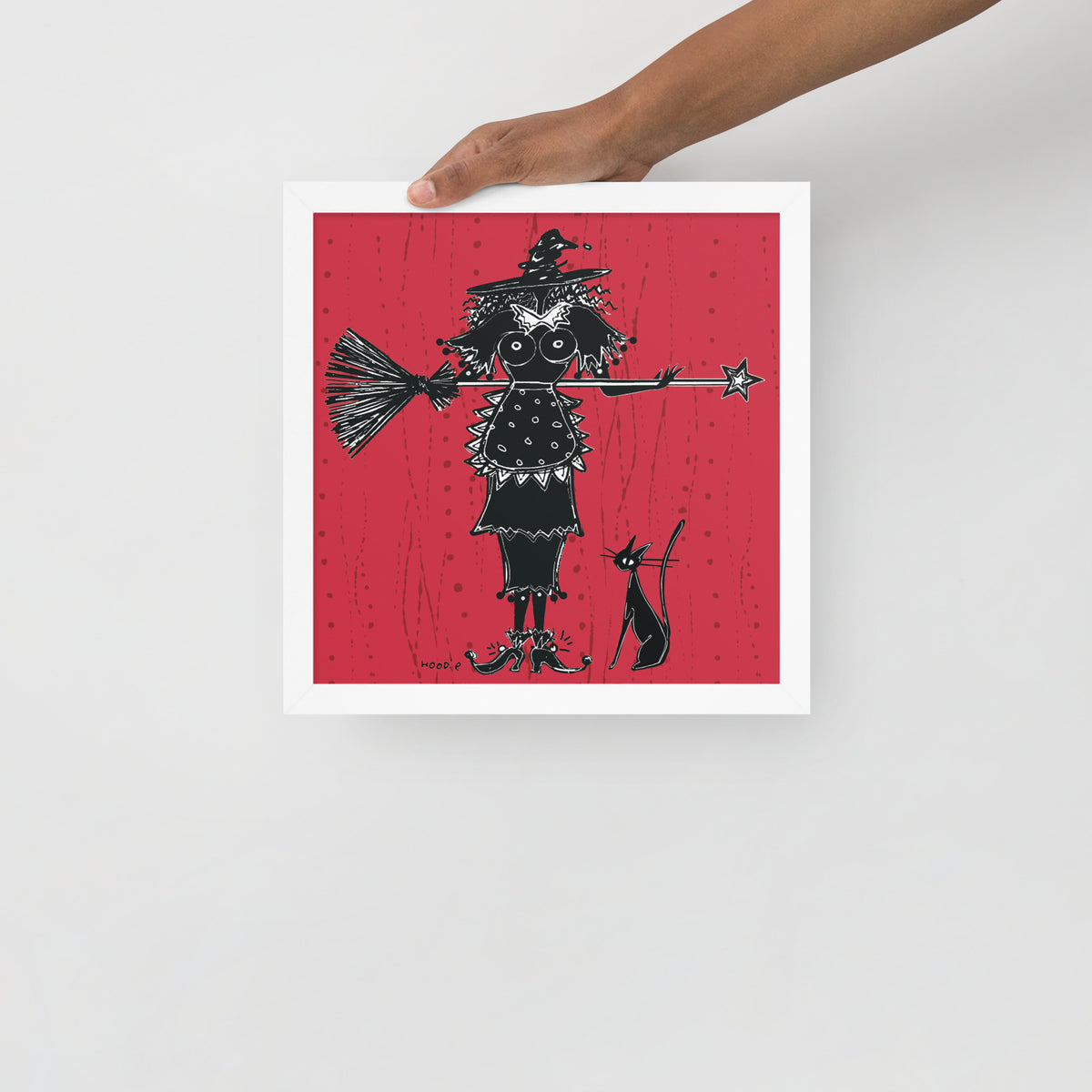 A witch holds a broom